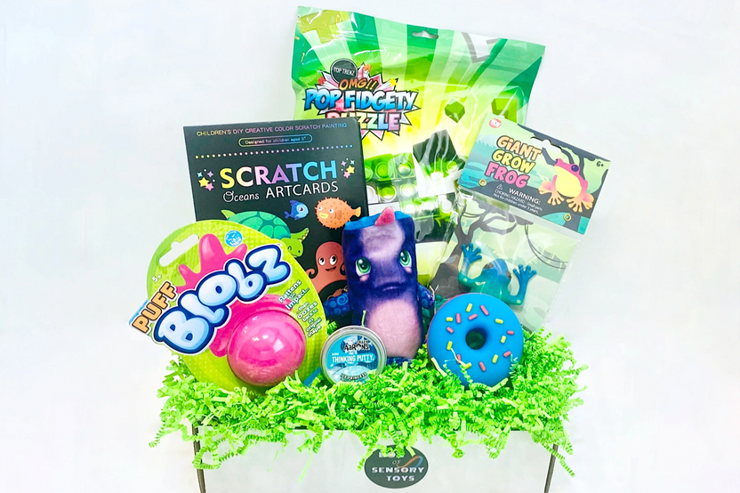 Colorful fidget toys including a Pop Fidgety Puzzle, Blobz, and a squishy donut in a subscription box for tweens