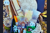 A Busy Witch Box featuring ritual tools, organic oils, and an altar card for Sabbat rituals in a witchcraft subscription box