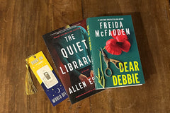 Two newly released paperback books and a bookmark. One is a historical fiction/suspense novel by Allen Eskens. The other by Freida McFadden.