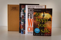 Brown subscription box filled with four fantasy novels, featuring magical worlds and adventurous plots for fans of imaginative storytelling