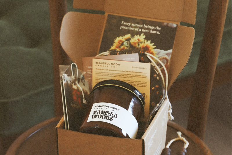 The Vibe Box amber candle in a kraft box