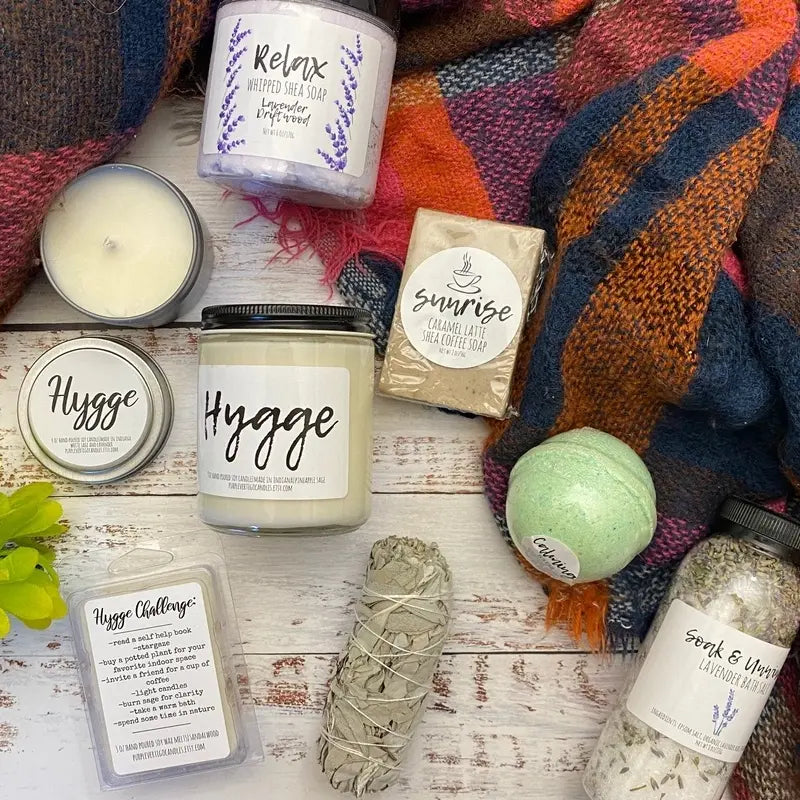 Overhead shot of a group of self care products including sage smudge, soap and candles