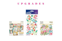 Colorful scrapbook papers and stickers in a monthly scrapbook kit featuring floral designs and cameras, ideal gifts for women