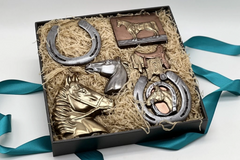Gift box with chocolate horses, detailed chocolate horseshoes, and a saddle-shaped treat for equestrian enthusiasts