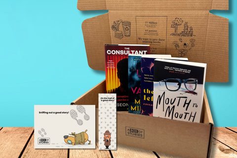 Brown box filled with fiction books, showcasing a variety of gripping titles and intriguing covers, perfect for mystery lovers.