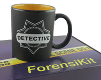 A blue box containing a forensikit is displayed in the back while a black detective mug is in the foreground