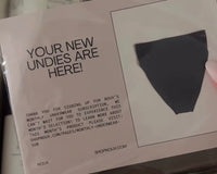 Someone holding a copy of their notecard in their hand that comes with each Noux subscription each month 