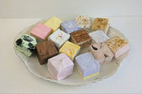 Assorted gourmet marshmallow squares in seasonal flavors made with real marshmallow root, on a white plate.