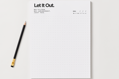 Let It Out notepad with a dotted grid page and a date line for no-filter journaling, shown with a black pencil