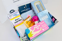 Colorful TEEN WISHBOX subscription box featuring socks, skincare items, and stationery, ideal holiday gift for teens