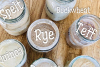 This image show's Risen Sourdough Starter Co.'s variations in the lines we offer! Rye, Teff. Quiona, Barley, Spelt and many more! 
