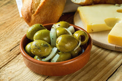 Gordal Olives by La Española. A symphony of colors and flavors. Pitted Gordal green olives seasoned with red pepper and whole garlic cloves.