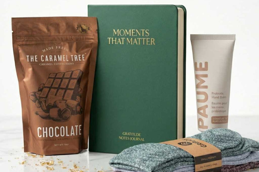 Open Senior Joy Box subscription box featuring snacks, a candle, and socks for aging parents on a cozy table setting