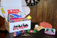 I heart candy a bunch box is perfect for everyone.  Box is shown here open with all the sweet treats in a recreational room. 