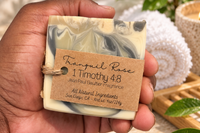 Hand holding Tranquil Rose handcrafted men's soap featuring a marbled design, natural ingredients and a masculine fragrance.