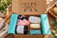 Tranquil Rose Deluxe Serenity gift box wrapped in elegant teal tissue paper with a thank-you seal and luxury presentation.    
