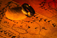 A person holding an open hardcover book with red edges, showcasing a cozy reading moment for book lovers with the Fantasy Books Club subscription