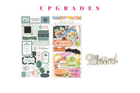 Colorful scrapbook papers and stickers in a monthly scrapbook kit featuring floral designs and cameras, ideal gifts for women
