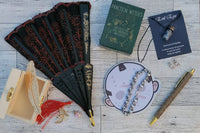 Small gifts with lace fan, Practical Witch's Spell Deck cards, Jason mask pad, evil eye necklace, gold pen, small wooden box 