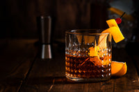 Classic Old Fashioned cocktail with an orange peel garnish, luxury cherries, and a crystal-clear ice