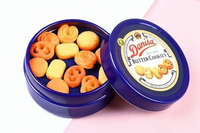 This is a photograph of a tiny blue miniature cookie tin of danish butter cookies.  The lid is off and you can see the cookies inside. 