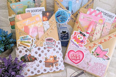 Blind date with a book wrapped in color papers with annotation supplies, bookmarks, book log, bookish stickers and sticker tabs