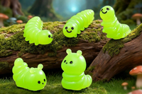 This is a photograph of tiny miniature glow in the dark inch worms.  The Inch worms are in various positions from crawling to sitting.