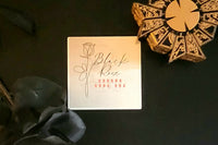 This picture is a close up of the Black Rose logo, the Hellraiser puzzle box, and a single black rose