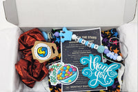 Starry night multicolored star cloth diaper subscription box with teething pacifier clip, stickers, scrunchie for mom and thank you cards.