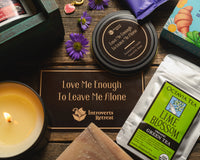 Introverts Retreat box image of a box with bath salt soaks, tea and candle plus a book on the side plus flowers.