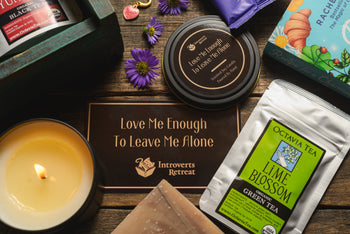 Introverts Retreat box image of a box with bath salt soaks, tea and candle plus a book on the side plus flowers.