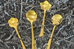 Set of 4 golden teaspoons, each with a unique design—perfect for stirring, serving, or adding charm to your daily ritual.