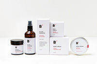 Six skin care and health products standing on each other and next to each other. All of them are white and the background is also white.