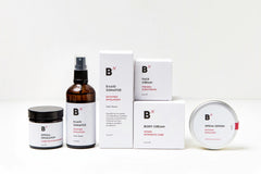 Six skin care and health products standing on each other and next to each other. All of them are white and the background is also white.