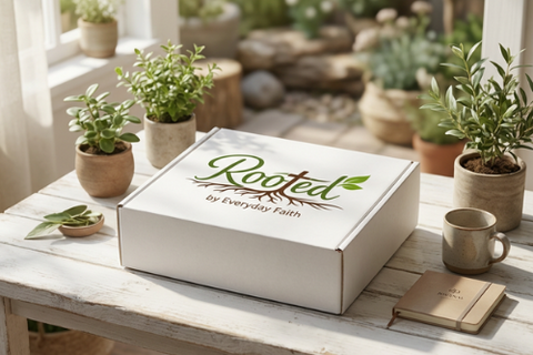 A woman reads a Bible while relaxing on a couch, showcasing the Rooted by Everyday Faith subscription box experience