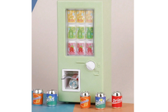 This is a photograph of a tiny miniature soda dispensing machine.   The sodas are red, green and orange. 