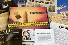 A Murder Mystery in a Box subscription box with an old newspaper, cards showing instructions, suspects and other clues.