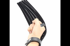 A leather whip that attaches to the hand, from a Kink Crate subscription box.