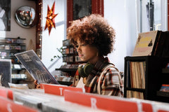 A vibrant, well-stocked vinyl record store with rows of neatly organized records on display