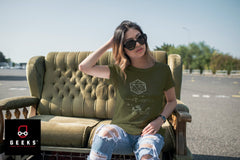 Lady sitting on a couch outside in a parking lot. She is wearing an olive green Dungeons and Dragons Shirt with an equation and 20 sided die