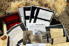 Vintage documents, vintage photographs and a newspaper article rest on top of papyrus and woodwool and vintage scarf and box