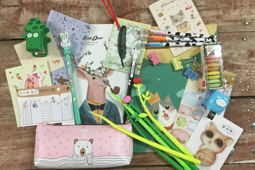 Assorted panda-themed stationery items from the Paper Overhaul subscription box, featuring notepads, stickers, and pens