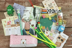Assorted panda-themed stationery items from the Paper Overhaul subscription box, featuring notepads, stickers, and pens