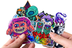 Colorful assortment of stickers from the Monthly Sticker Savages Box featuring monsters and whimsical designs for water bottle stickers