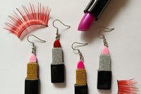 Colorful assortment of unique earrings including food and whimsical designs in the Monthly Earring Mania subscription box