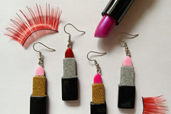 Colorful assortment of unique earrings including food and whimsical designs in the Monthly Earring Mania subscription box