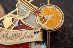 Close up on the Mulled wine drink pin. Many printed details on the orange slice and translucent enamel details.