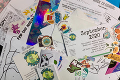 Pic shows actual contents of a Quirky Pickle pack from September 2020. There are stickers, cards, activities, and more.