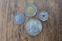An example of foreign coins included in the coin collector's gift boxes, including Japanese yen, Philippine Peso, and more.