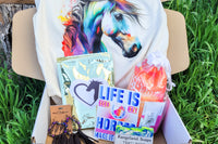 The Stable Box Subscription - horse girl graphic tee, horse treats, pink saddle pad cover, vinyl sticker and earrings.